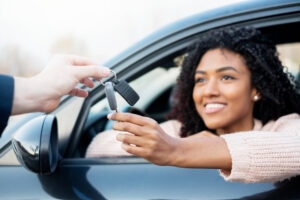 Portrait of young black woman sitting in car stock photo